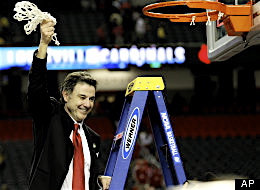 Rick Pitino cutting down the nets after defeating Michigan.