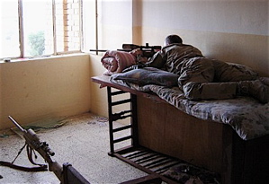 Chris Kyle set up in an improvised sniper hide, using a baby crib.