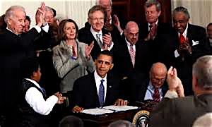 President Obama shows that insurance rebate checks are in the mail.