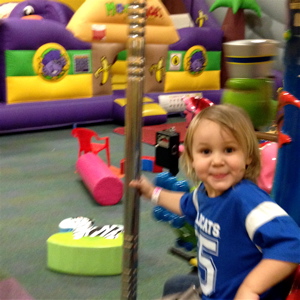 Isabella at Monkey Joe's rocking the Merry-Go-Round.