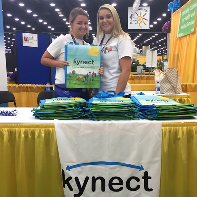 kynect staff members Shelby Warren, left, and Jasmine Hall, working the health exchange booth at the 2015 KY State Fair.
